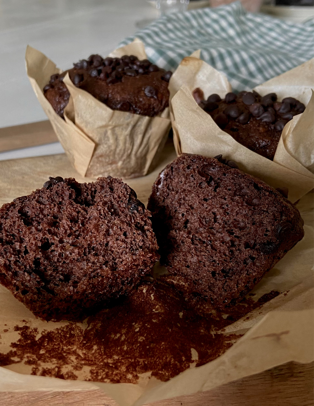 A chocolate banana muffin torn in half to show the texture inside.