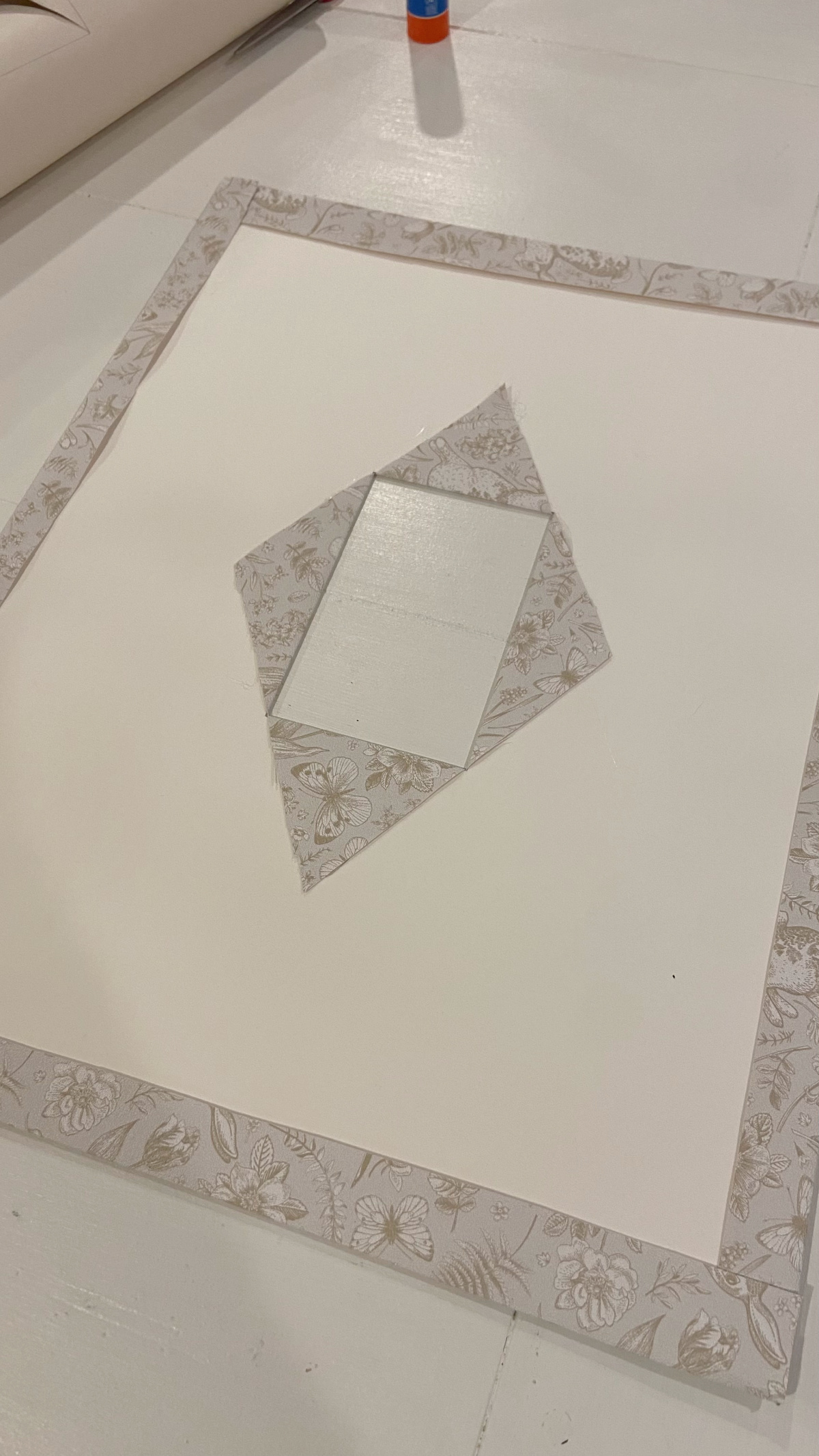 The wallpaper flaps folded over and glued in place to the photo mat.