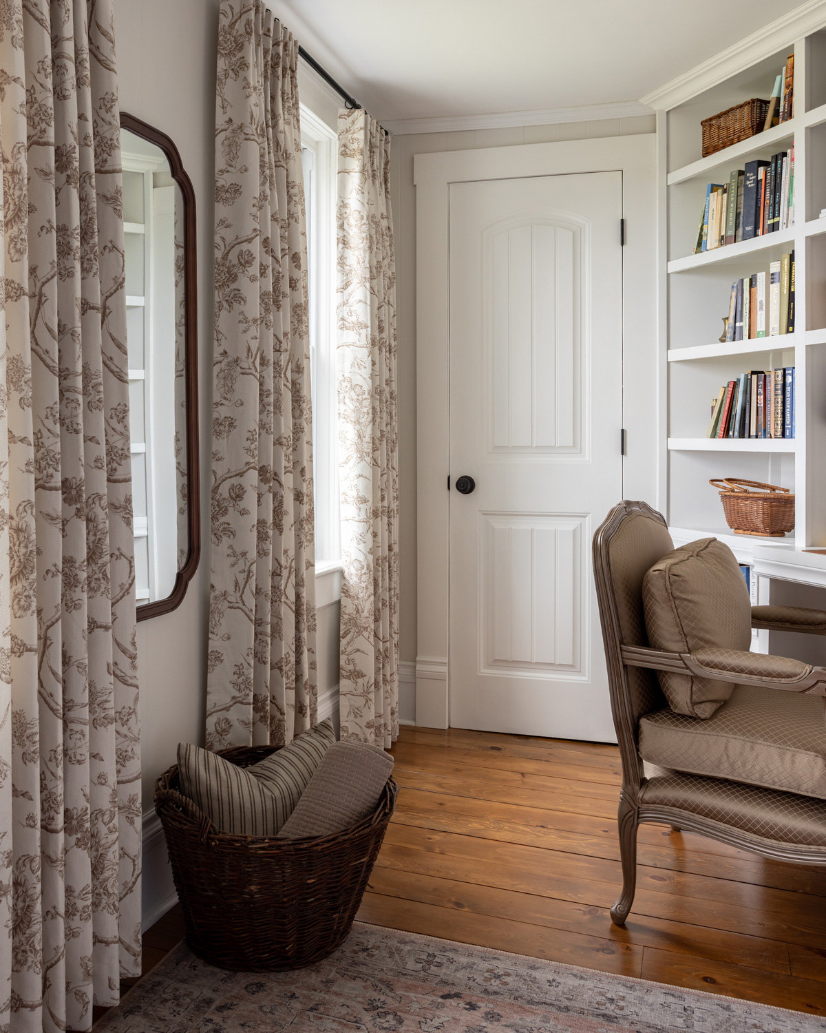 Toile curtains from Curtarra in a bedroom with built-in bookshelves.