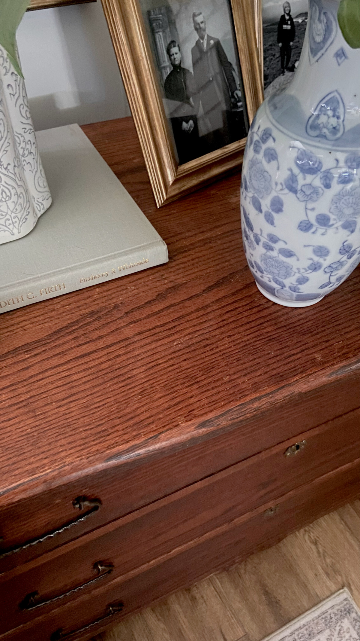 A water stain on an antique dresser, almost fully removed after the process.