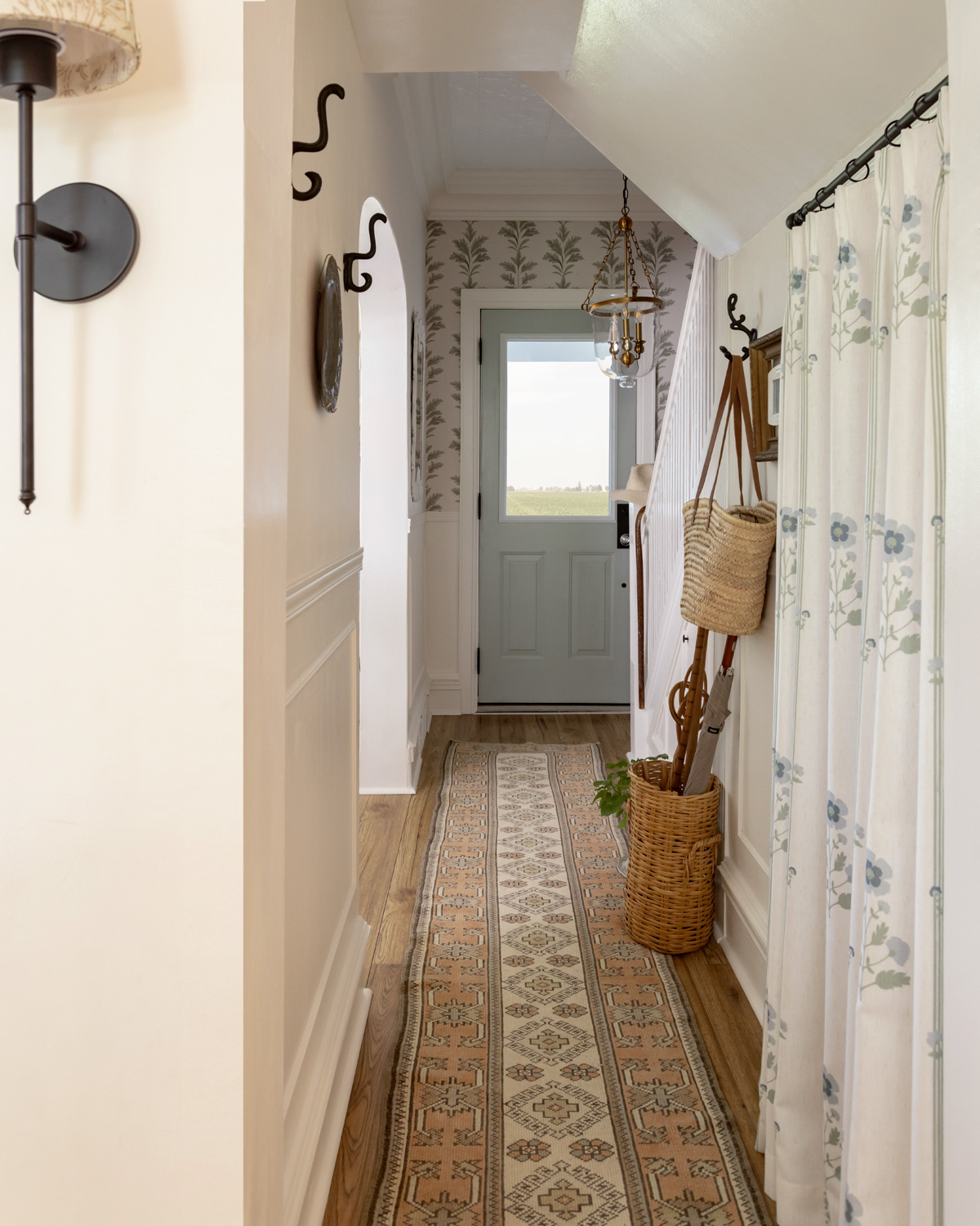 Blue door in a hallway with a vintage Turkish rug.