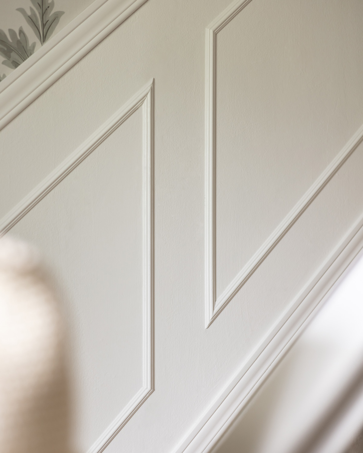 Wainscoting on the stair wall painted Benjamin Moore White Dove.