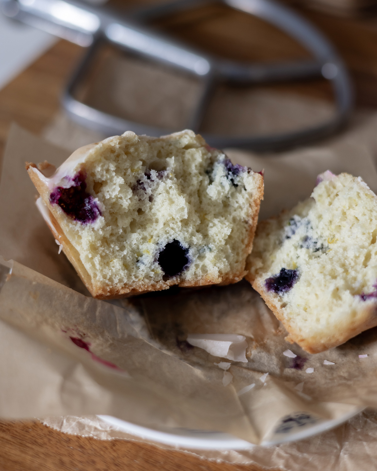 A lemon blueberry muffin torn open to reveal texture.