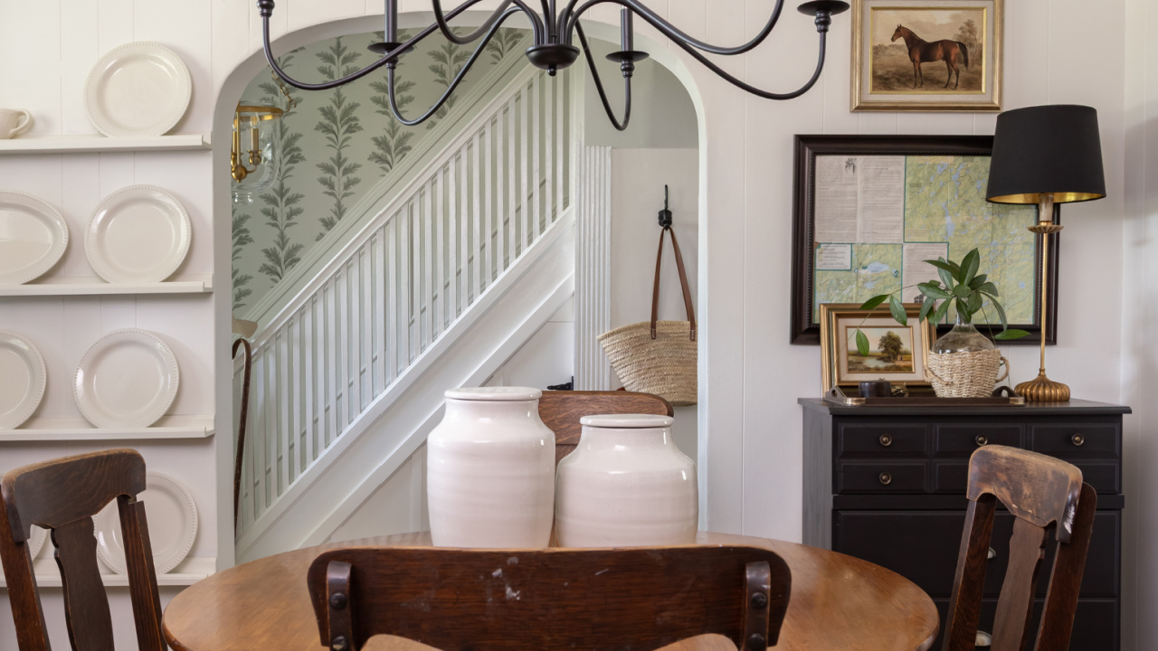 A dining room and hallway decorated in a traditional style.