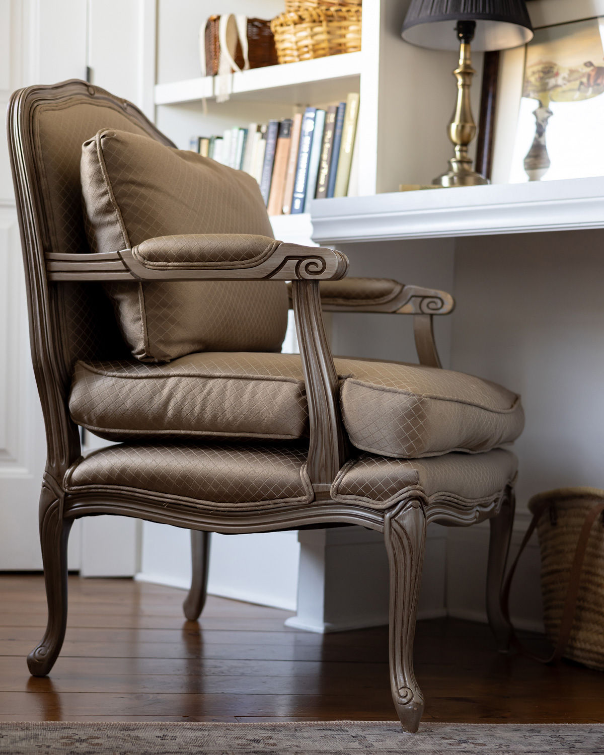 Vintage Bergere chair in front of a built-in desk.