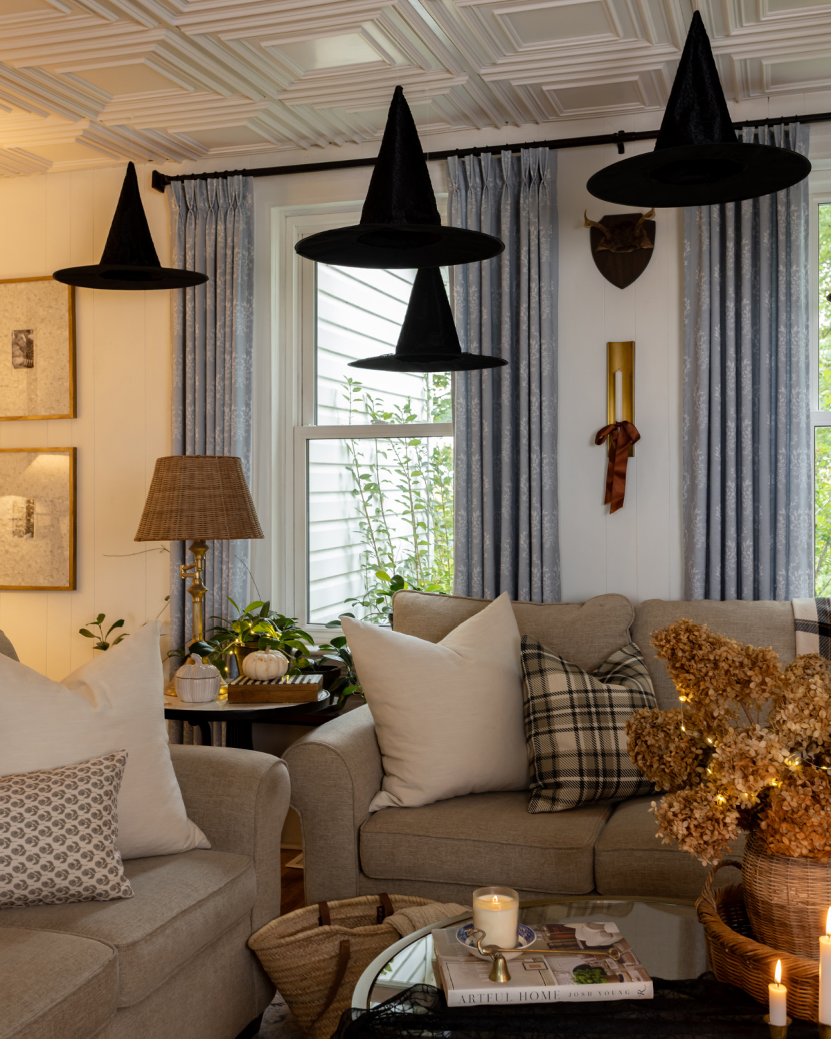 Floating black witch hats in a living room decorating for Halloween.