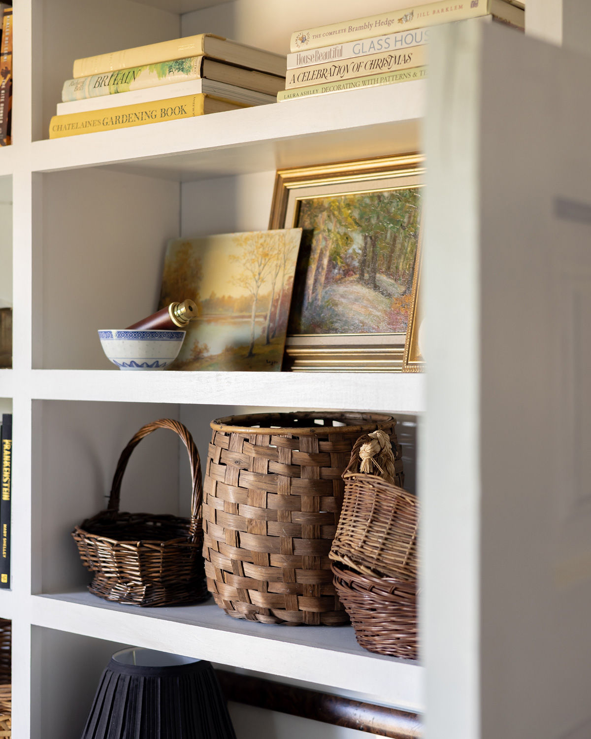 A collection of vintage baskets, art, and books.